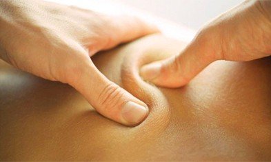 A person receiving a deep tissue massage on their back.