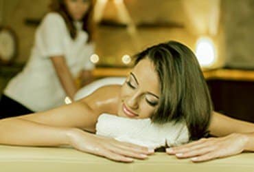 A woman getting a massage at a spa.