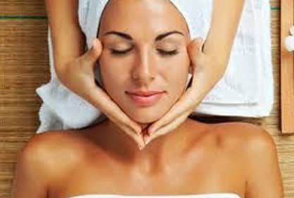 A woman enjoying a special offer facial massage at a spa.