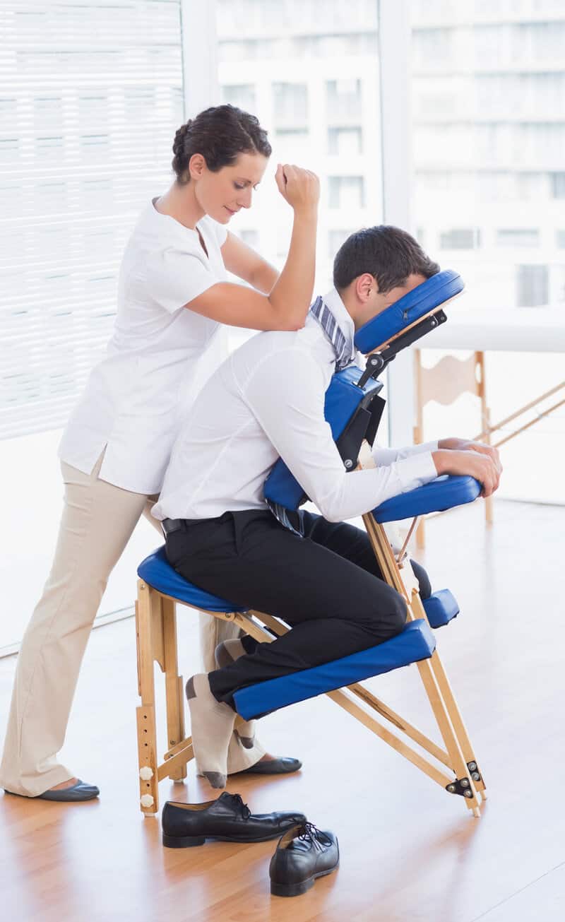 A woman is getting a massage in a chair.