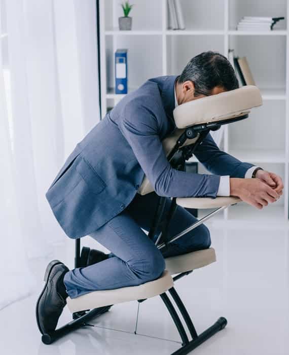 A man sitting on a massage chair.