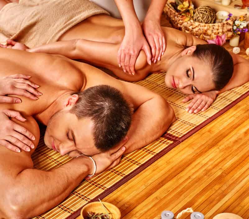 A man and woman getting a massage in a spa.