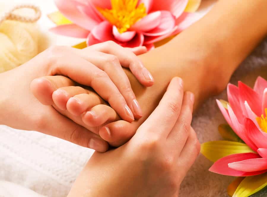 A woman getting a foot massage in a spa.