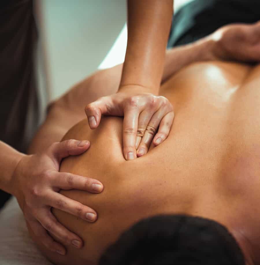 A man getting a back massage at a spa.