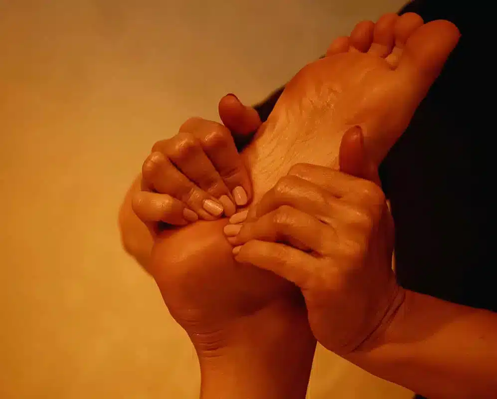 A woman's foot is being massaged by another person. A woman's foot is being massaged by another person.