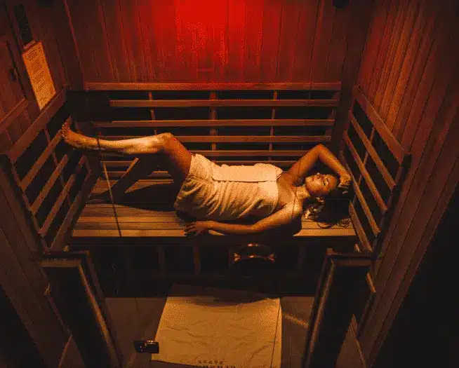wellness-img A woman laying down in an infrared sauna.